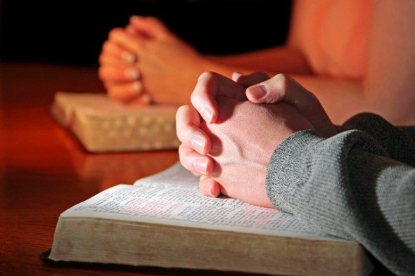 Couple praying with bible