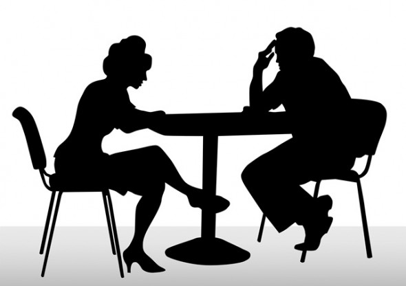 two people talking at table
