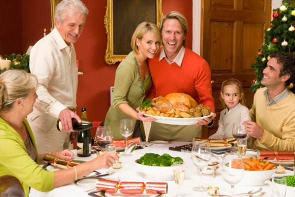 Family gathering around table for holiday dinner