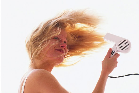woman blow drying hair